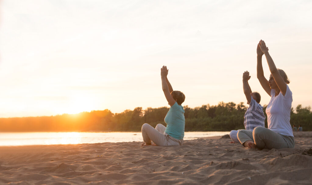 Gruppe praktiziert Tai Chi am Meer